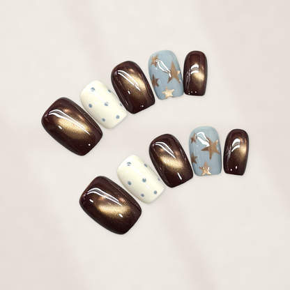 Autumn Cocoa Starfall Short Squoval Press-On Nails with Bronze Cat-Eye Glow, Blue Starbursts, and Glossy Cream Dots 16mm