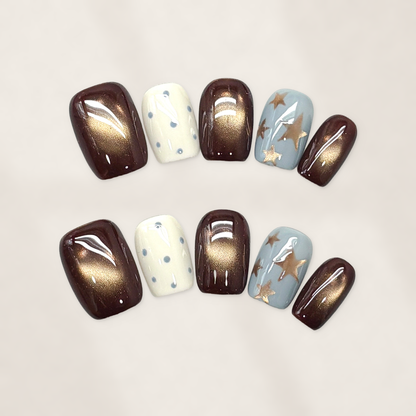 Autumn Cocoa Starfall Short Squoval Press-On Nails with Bronze Cat-Eye Glow, Blue Starbursts, and Glossy Cream Dots 16mm
