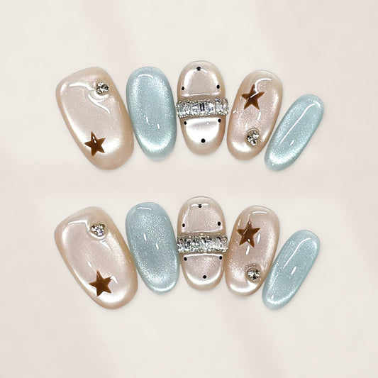 Celestial Champagne and Ice Blue Oval Press-On Nails with Crystal Bands and Golden Stars 20mm