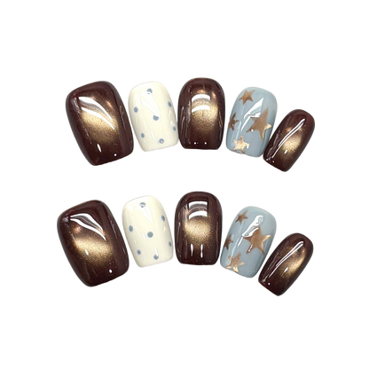 Autumn Cocoa Starfall Short Squoval Press-On Nails with Bronze Cat-Eye Glow, Blue Starbursts, and Glossy Cream Dots 16mm