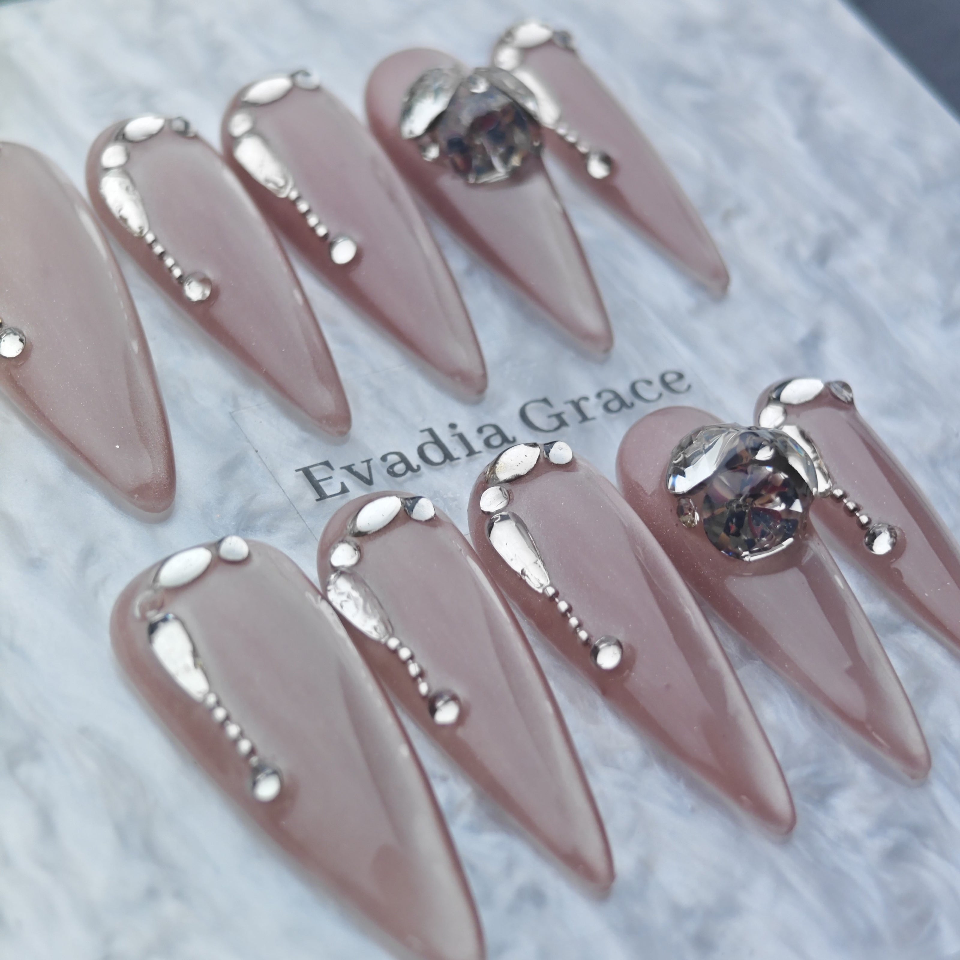 Nude Chrome Drip Nails – Silver Liquid Metal Accent with Crystal Gem