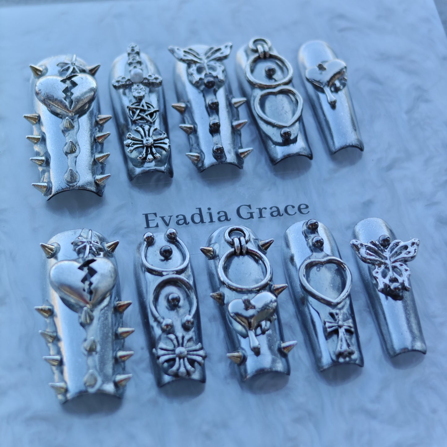 Silver Armor Nails – Spiked Chrome Press-On Nails with Heart, Cross & Butterfly Accents | Cyber Gothic Punk Design by Evadia Grace