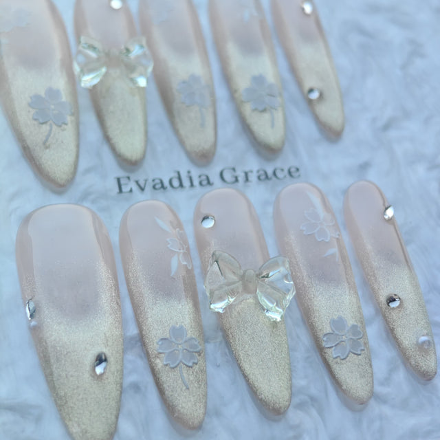 Blossom Glow Nails – Nude Gold Gradient Press-On Nails with Clear Bow & White Sakura Art | Elegant Japanese Floral Nails by Evadia Grace