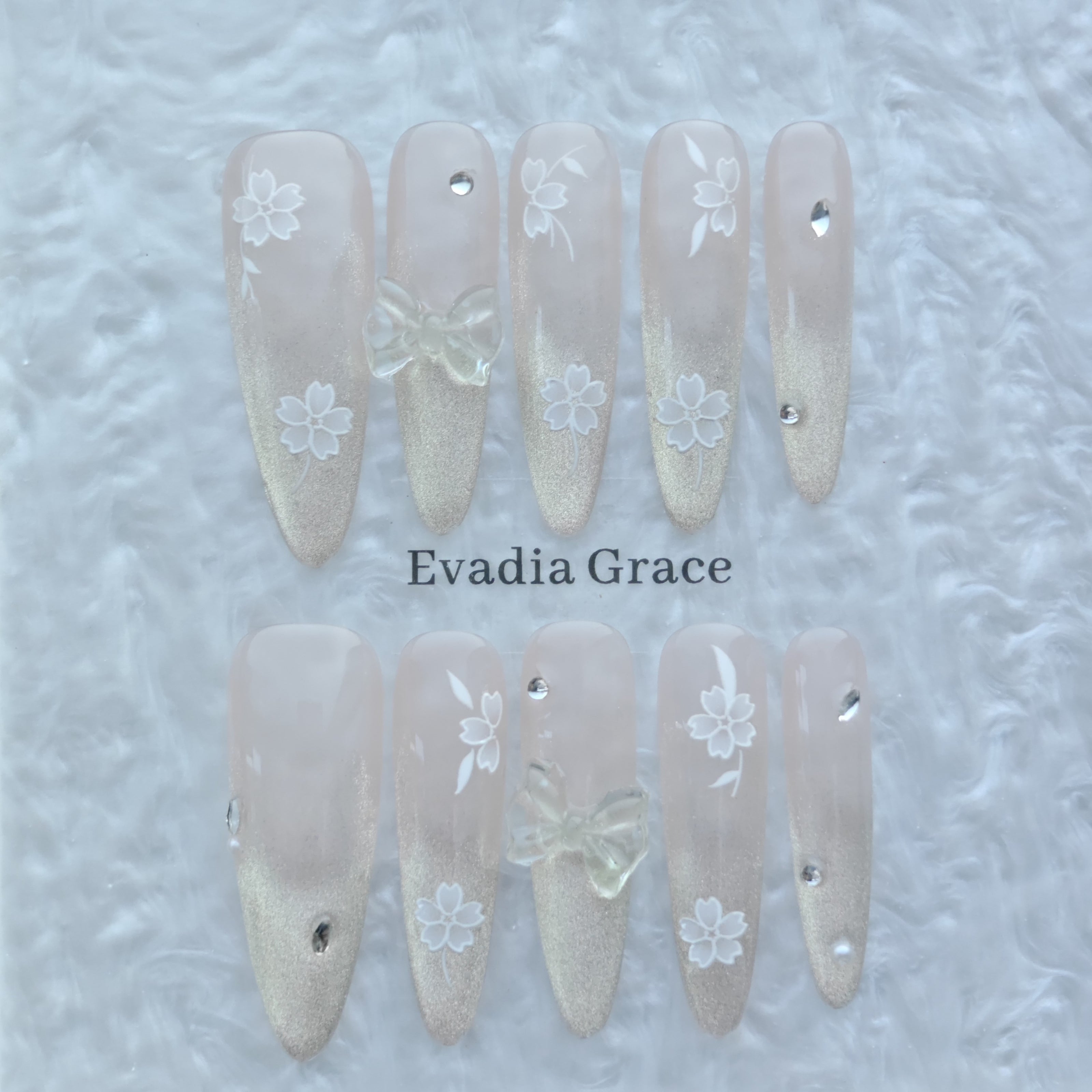 Blossom Glow Nails – Nude Gold Gradient Press-On Nails with Clear Bow & White Sakura Art | Elegant Japanese Floral Nails by Evadia Grace