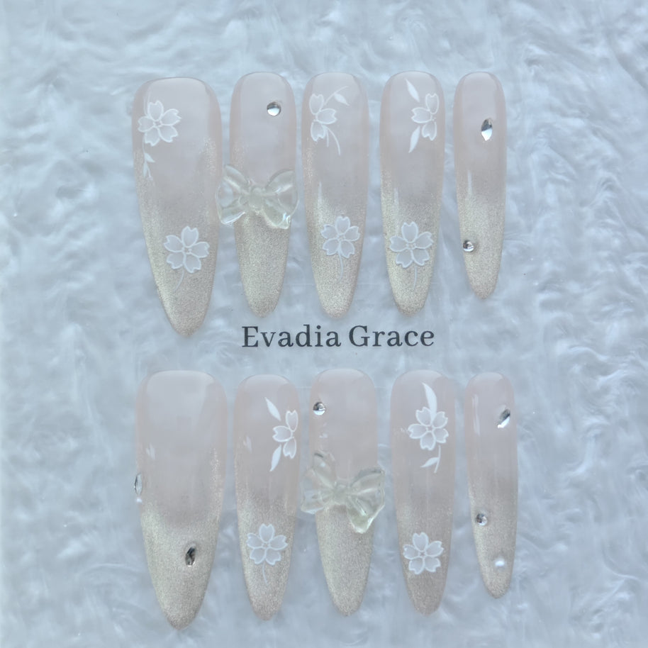 Blossom Glow Nails – Nude Gold Gradient Press-On Nails with Clear Bow & White Sakura Art | Elegant Japanese Floral Nails by Evadia Grace