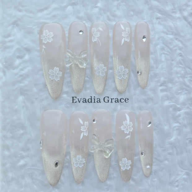 Blossom Glow Nails – Nude Gold Gradient Press-On Nails with Clear Bow & White Sakura Art | Elegant Japanese Floral Nails by Evadia Grace