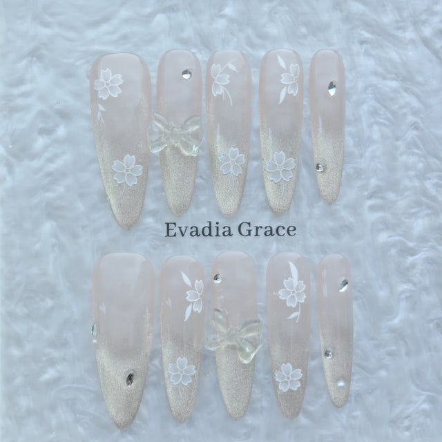 Blossom Glow Nails – Nude Gold Gradient Press-On Nails with Clear Bow & White Sakura Art | Elegant Japanese Floral Nails by Evadia Grace