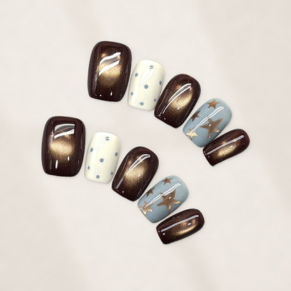 Autumn Cocoa Starfall Short Squoval Press-On Nails with Bronze Cat-Eye Glow, Blue Starbursts, and Glossy Cream Dots 16mm